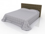 Double bed with upholstered headboard and quilt